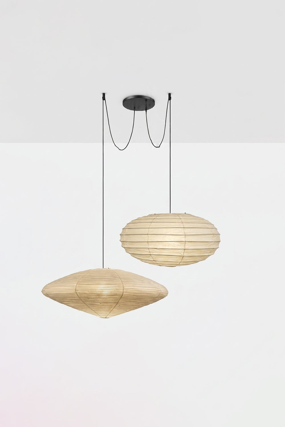 Komorebi Mulberry Paper Pendant Light | Paper, Bamboo | Studio view of a lit 3-light combination variant with two flat saucer shades and one sphere casting a warm glow | vexa lamps