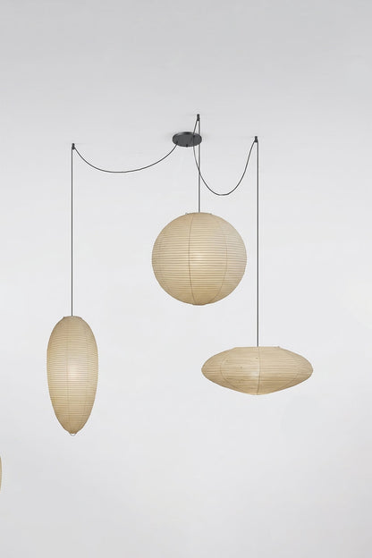 Komorebi Mulberry Paper Pendant Light | Paper, Bamboo | Studio view of an unlit 3-light combination variant featuring an oval, sphere, and saucer shade on black cords | vexa lamps