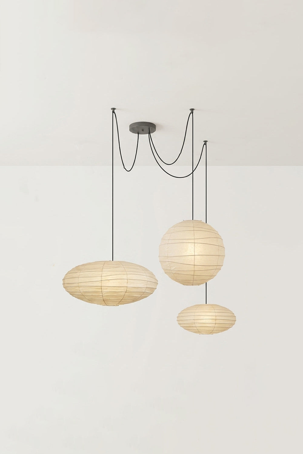 Komorebi Mulberry Paper Pendant Light | Paper, Bamboo | Studio view of an unlit 3-light multi-pendant arrangement showing two wide saucers and a central sphere | vexa lamps