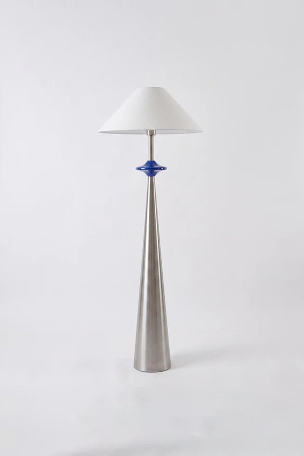 Lazuro Postmodern Cone Floor Light | Metal, Fabric | Studio full-length view of the unlit tapered silver floor fixture showcasing its sculptural silhouette against a white backdrop | vexa lamps