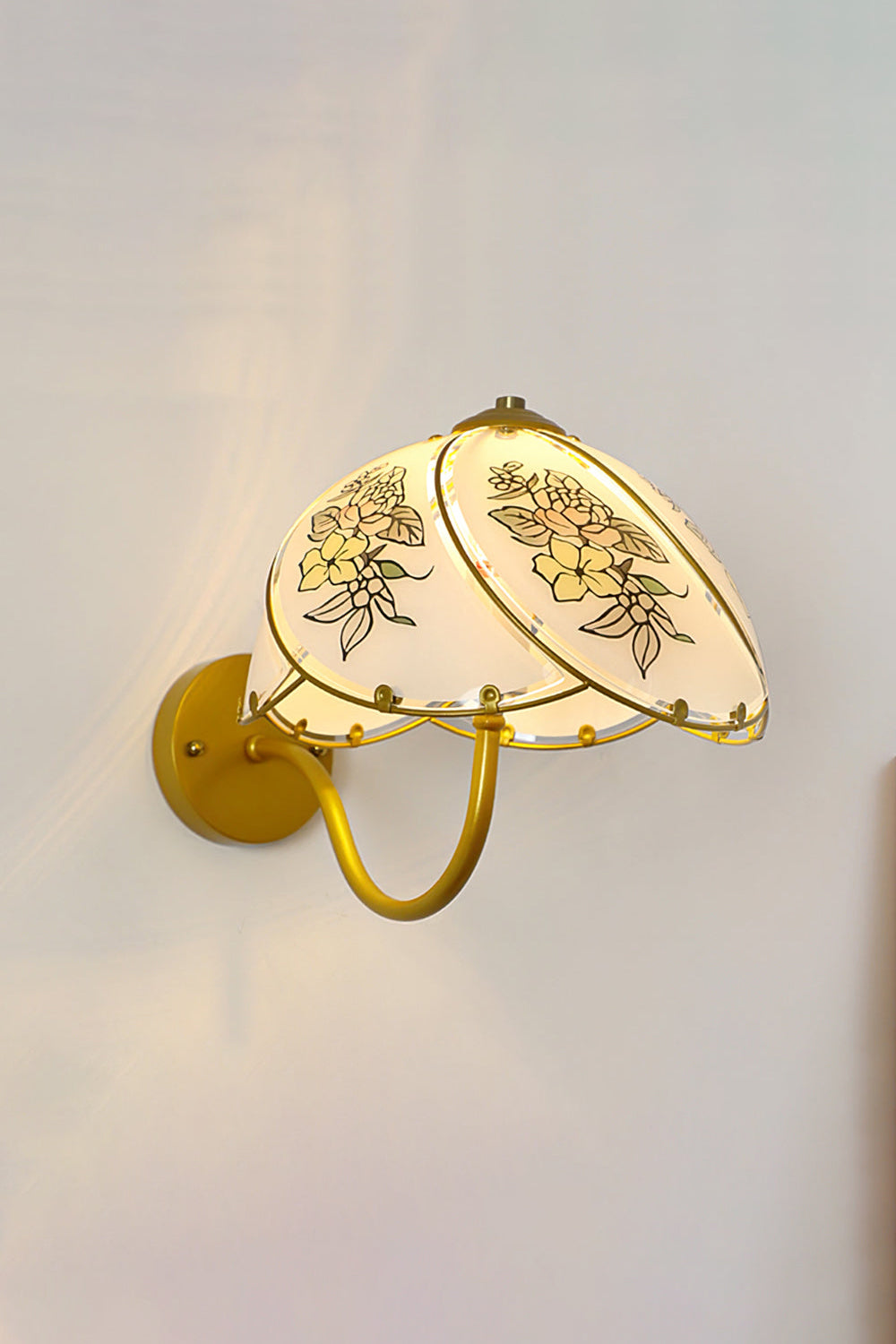 Lillian Retro Floral Wall Lamp | Glass, Metal | Frontal view of the fully lit retro floral sconce casting a warm golden backlight halo on a neutral wall | vexa lamps