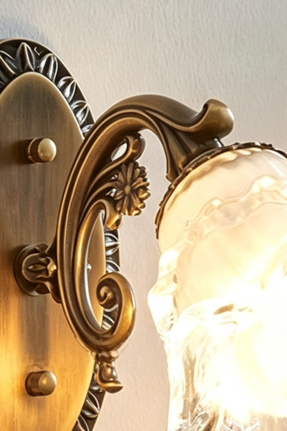 Lisette Blossom Glass Brass Wall Lamp | Glass and Brass | Close-up detail of the ornate carved brass scroll arm and glass shade holder | vexa lamps