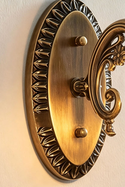 Lisette Blossom Glass Brass Wall Lamp | Glass and Brass | Detail shot showing the oval carved antique brass mounting backplate | vexa lamps