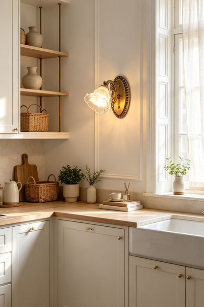 Lisette Blossom Glass Brass Wall Lamp | Glass and Brass | Installed on a white wall in a bright kitchen over a wooden counter | vexa lamps