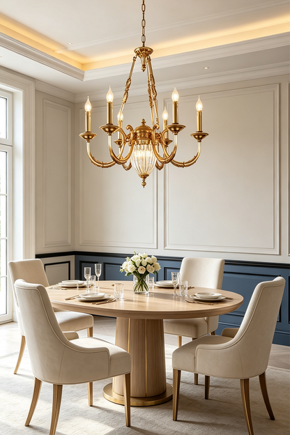 Lucienne Fluted Glass Urn Brass Chandelier illuminating an elegant dining room with a round table and stylish chairs.