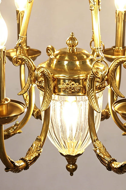 Lucienne Fluted Glass Urn Brass Chandelier featuring elegant gold detailing and illuminated fluted glass accents.