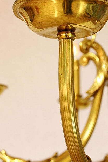 Close-up of Lucienne Fluted Glass Urn Brass Chandelier showcasing its elegant brass detailing.