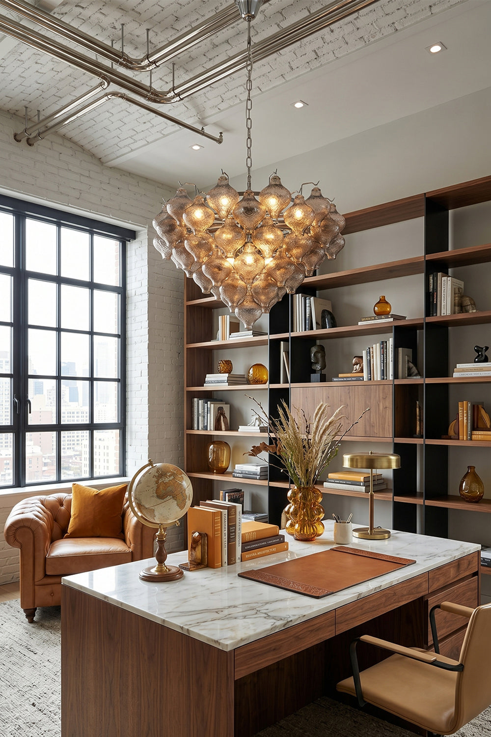 Lucina Tiered Smoked Glass Chandelier illuminating a modern office with a stylish desk and bookshelf.