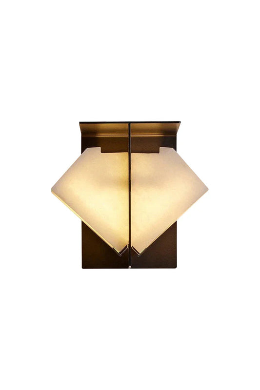 Lysandra Alabaster Folded Halo Wall Lamp | Alabaster, Bronze | Isolated lit view of an architectural geometric wall sconce featuring a folded diamond envelope-like natural white alabaster shade on a dark bronze backing plate | White background | vexa lamps