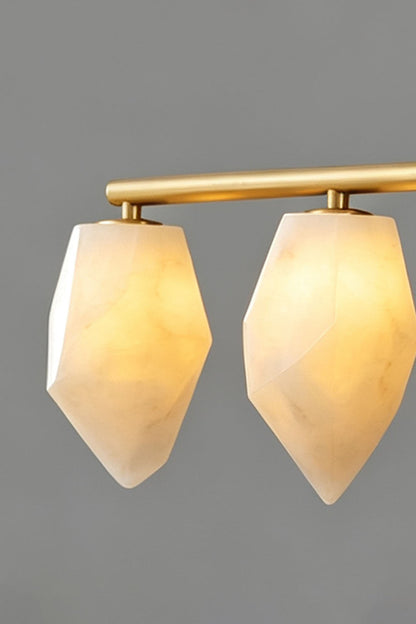 Manon Alabaster Drop Linear Chandelier | Natural Alabaster and Brass | Medium close-up showing two glowing alabaster drop shades against a dark backdrop | vexa lamps