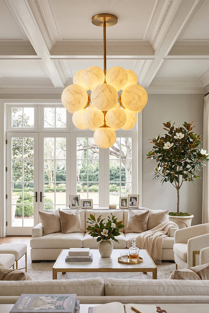 Marcella Alabaster Grape Cluster Chandelier illuminating a stylish living room with natural light.