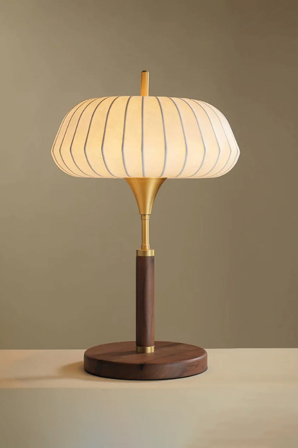 Maren Woven Silk Gourd Table Lamp | Woven Silk, Brass and Wood | Warm ambient front view highlighting the glowing silk shade | vexa lamps
