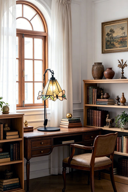 Mariposa Stained Glass Table Lamp | Glass, Metal | Illuminating a corner study workspace next to built-in wooden bookshelves and a large window | vexa lamps
