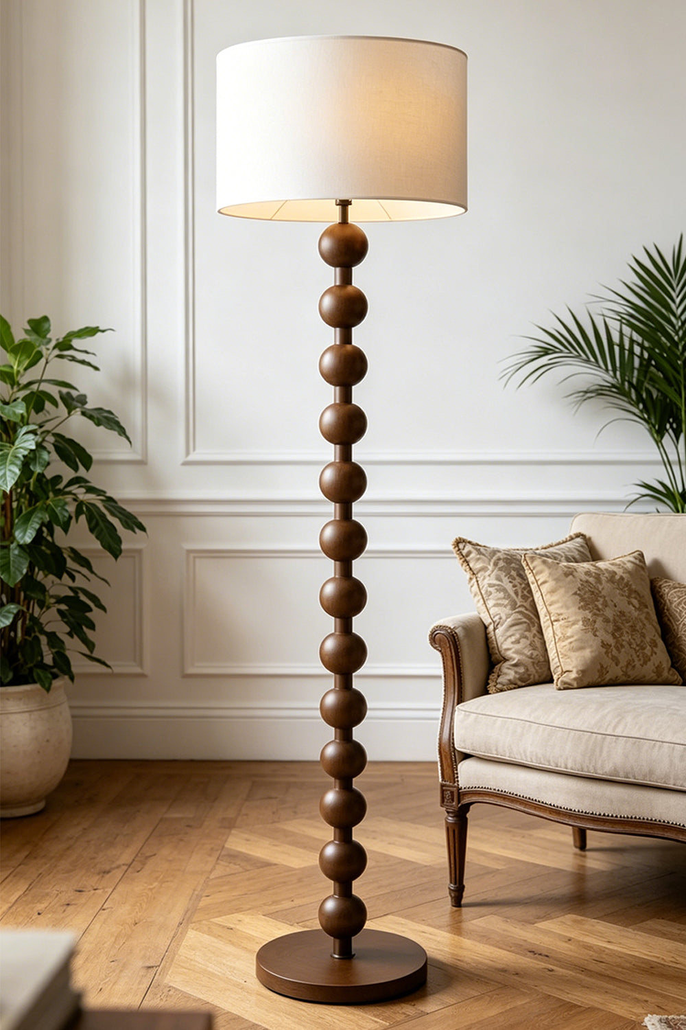 Marlow Stacked Wood Floor Lamp | Wood, Fabric | Placed in a cozy living room nook, providing soft ambient lighting next to a cream armchair on a classic herringbone wood floor | vexa lamps
