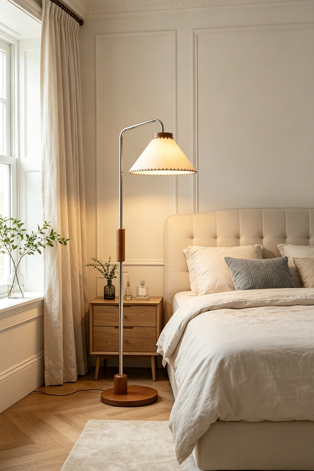 Marlowe Angled Linen Reading Floor Lamp | Linen, Wood, and Chrome Metal | Standing in a cozy bedroom beside a cream tufted bed and a wooden nightstand by the window | vexa lamps