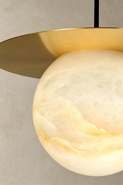 Marne Alabaster Sphere Brass Pendant Light | Natural Alabaster and Brass | Close-up shot showing the illuminated natural stone veining on the globe | vexa lamps