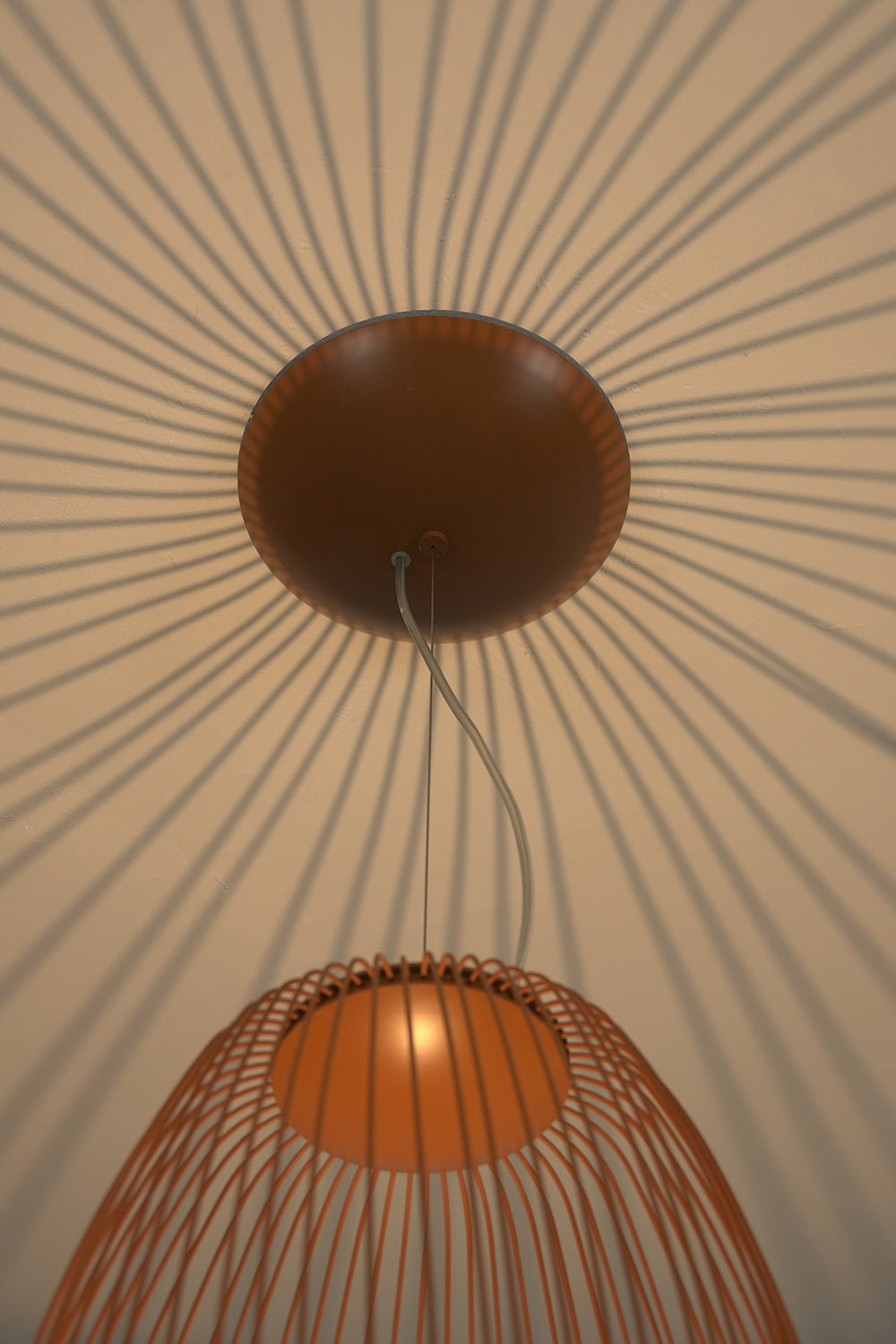 Shadow patterns cast by elliptical wire cage lamp | Aluminum | Artistic ceiling detail with light and shadow | vexa lamps