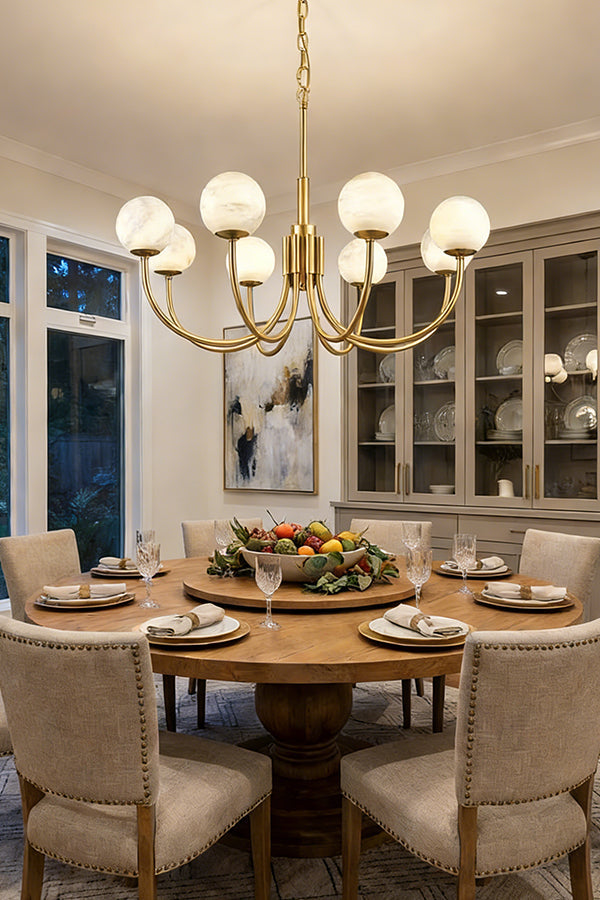 Modern brass and alabaster globe chandelier | Alabaster, Brass | Installed over a round dining table with upholstered chairs | vexa lamps