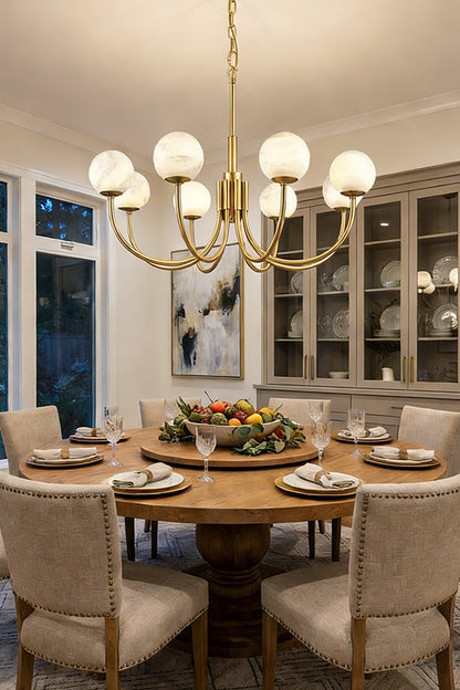 Modern brass and alabaster globe chandelier | Alabaster, Brass | Installed over a round dining table with upholstered chairs | vexa lamps