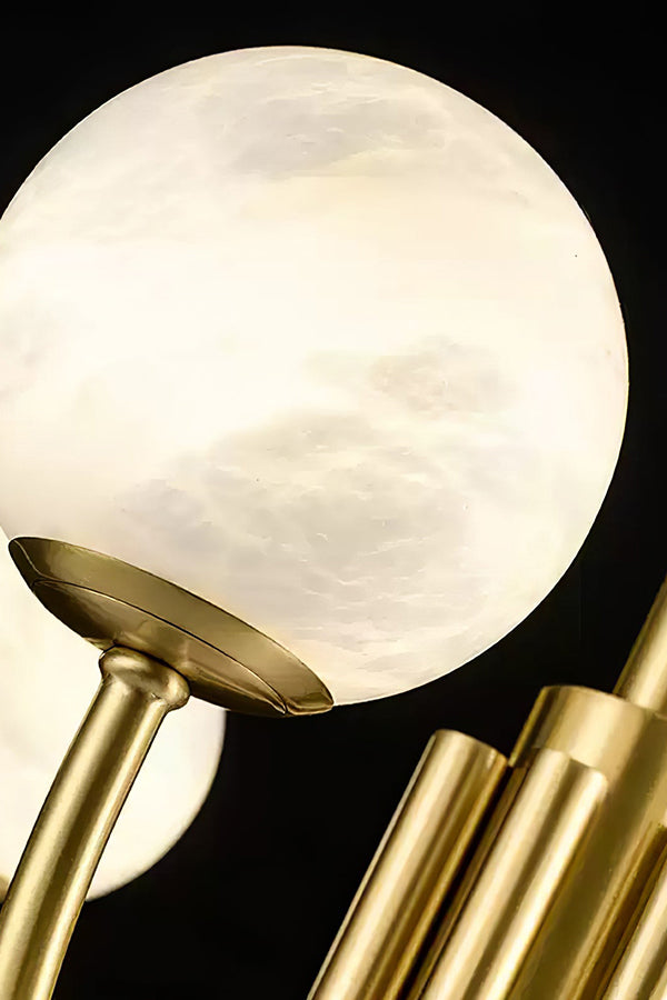 Detail of brass chandelier arms and globe base | Brass, Alabaster | Macro shot showing the metallic texture and stone | vexa lamps