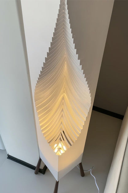 Nori Sculptural Leaf Floor Lamp | Fabric, Wood | Close-up side profile view of the glowing ribbed geometric folds of the sculptural white fabric shade | Detail shot | vexa lamps