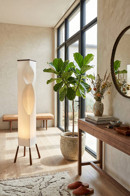 Nori Sculptural Leaf Floor Lamp | Fabric, Wood | Close-up corner shot highlighting the warm golden glow of the layered leaf-like structure near window blinds | vexa lamps