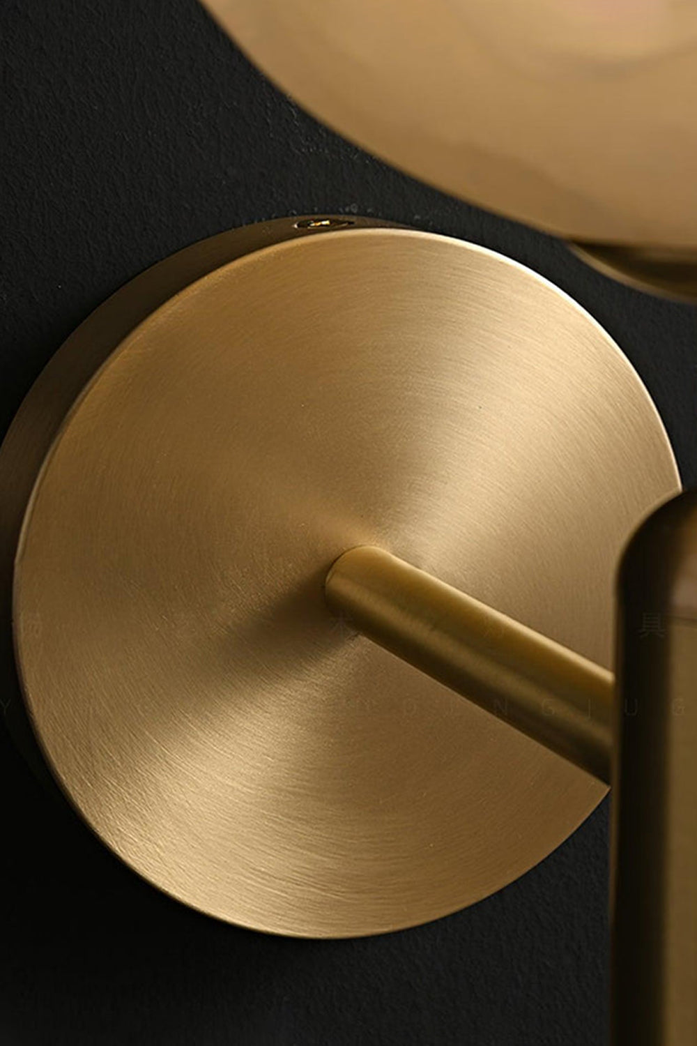 Ondine Alabaster Blossom Wall Sconce | Natural Alabaster and Brass | Detailed macro shot focusing on the smooth finish of the circular brass backplate and stem bottom | vexa lamps