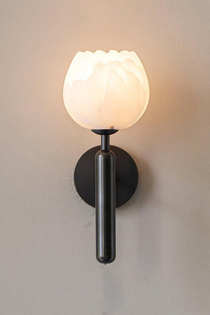 Ondine Alabaster Blossom Wall Sconce | Natural Alabaster and Black Metal | Full view of the illuminated tulip stone fixture featuring a matte black finish stem and base option | vexa lamps
