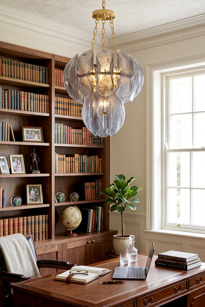 Ondine Cascading Leaf Glass Chandelier | Textured Smoked Glass and Gold Metal | Illuminating a sophisticated home library office filled with wooden bookshelves and a large executive desk | vexa lamps