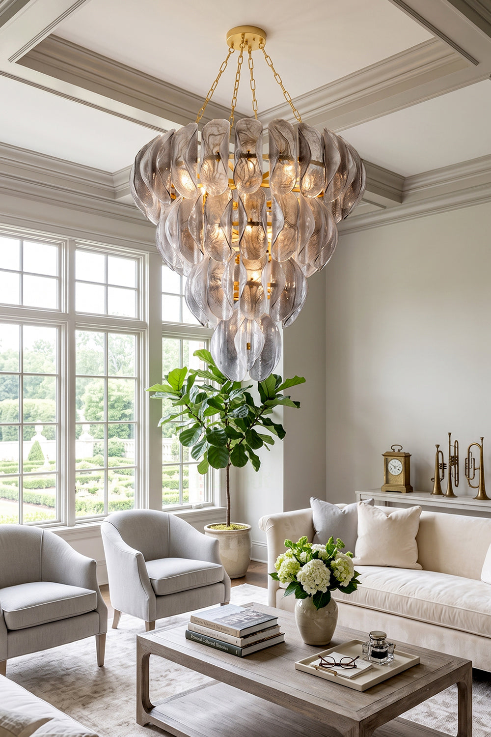 Ondine Cascading Leaf Glass Chandelier | Textured Smoked Glass and Gold Metal | Styled under a coffered ceiling in a spacious bright living room with elegant grey fabric sofas | vexa lamps