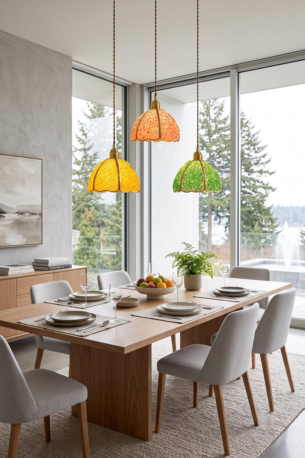 Ondine Mosaic Glass Pendant Light in vibrant colors illuminating a modern dining area with table and chairs.