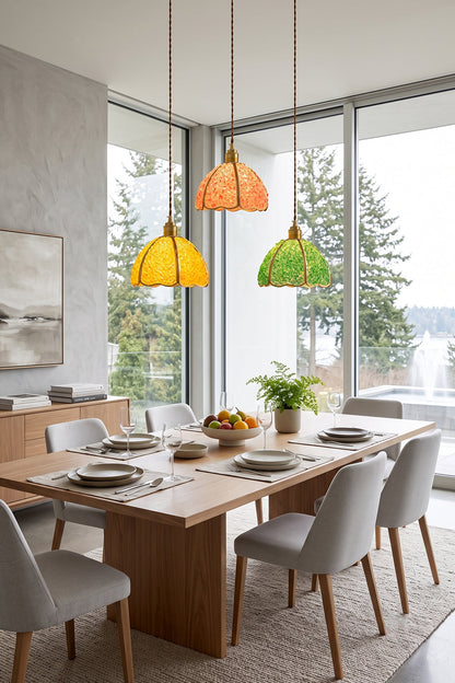 Ondine Mosaic Glass Pendant Light in vibrant colors illuminating a modern dining area with table and chairs.