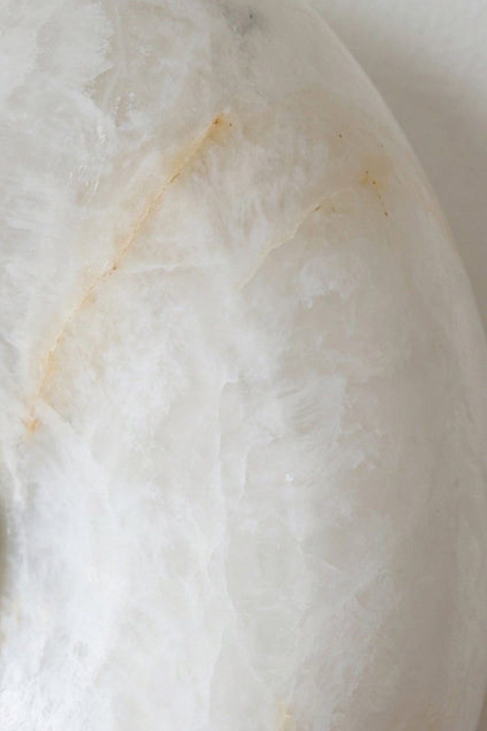 Close-up of the unique veining in Ondine Ring Alabaster Wall Sconce made from natural alabaster.
