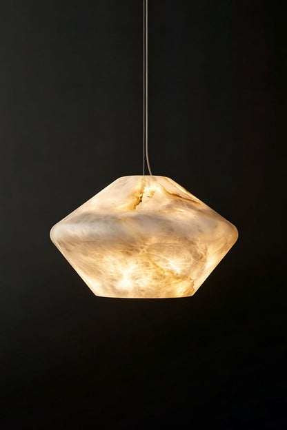 Ottilie Barrel Alabaster Pendant Light | Natural Alabaster and Metal | Studio shot of the illuminated wide alabaster pendant on a dark background | vexa lamps