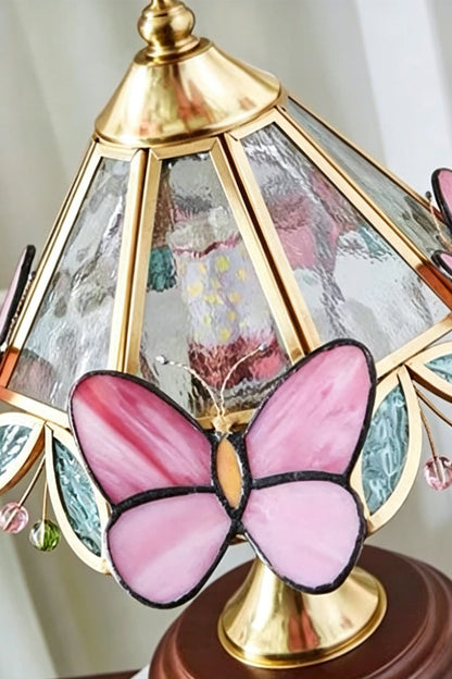 Papillon Heirloom Stained Table Lamp | Wood, Glass, Metal | Close-up angled view showcasing the vibrant translucent pink stained glass butterfly embellishment | Detail shot | vexa lamps