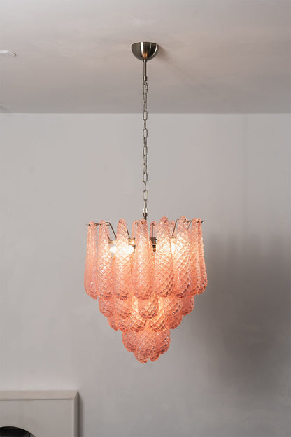 Amara Blush Cascading Glass Chandelier | Glass, Metal | Frontal view of the fully illuminated pink glass chandelier against a clean, plain studio wall | vexa lamps