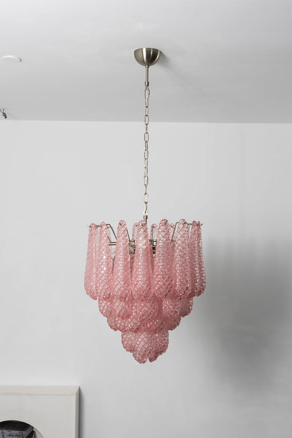 Amara Blush Cascading Glass Chandelier | Glass, Metal | Full tiered view of the illuminated pink glass chandelier casting soft ambient light against a studio backdrop | vexa lamps