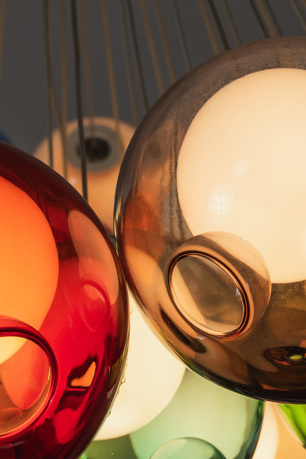 Rainbow Glass Bubble Cluster Chandelier | Glass, Metal | Macro close-up focus on the glossy reflective surfaces of interlocking red, amber, and orange glass bubble globes | Detail shot | vexa lamps