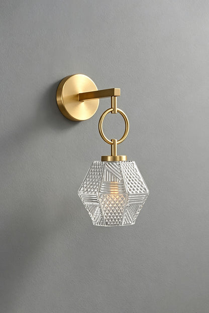 Rosamund Faceted Glass Wall Sconce | Faceted Glass and Brass | Unlit front view of the brass sconce on a grey wall | vexa lamps