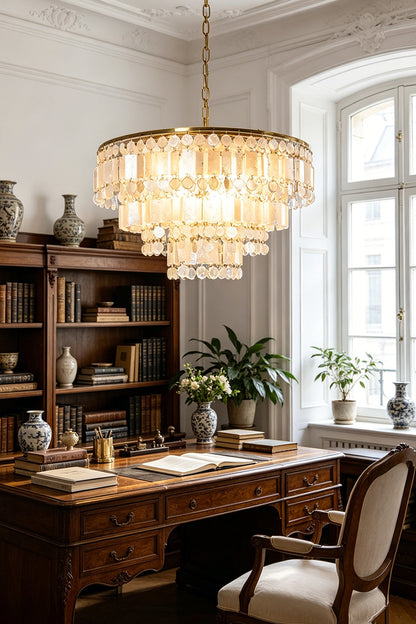 Seraphina Capiz Cascade Metal Chandelier in a stylish office setting with a wooden desk and bookshelves.