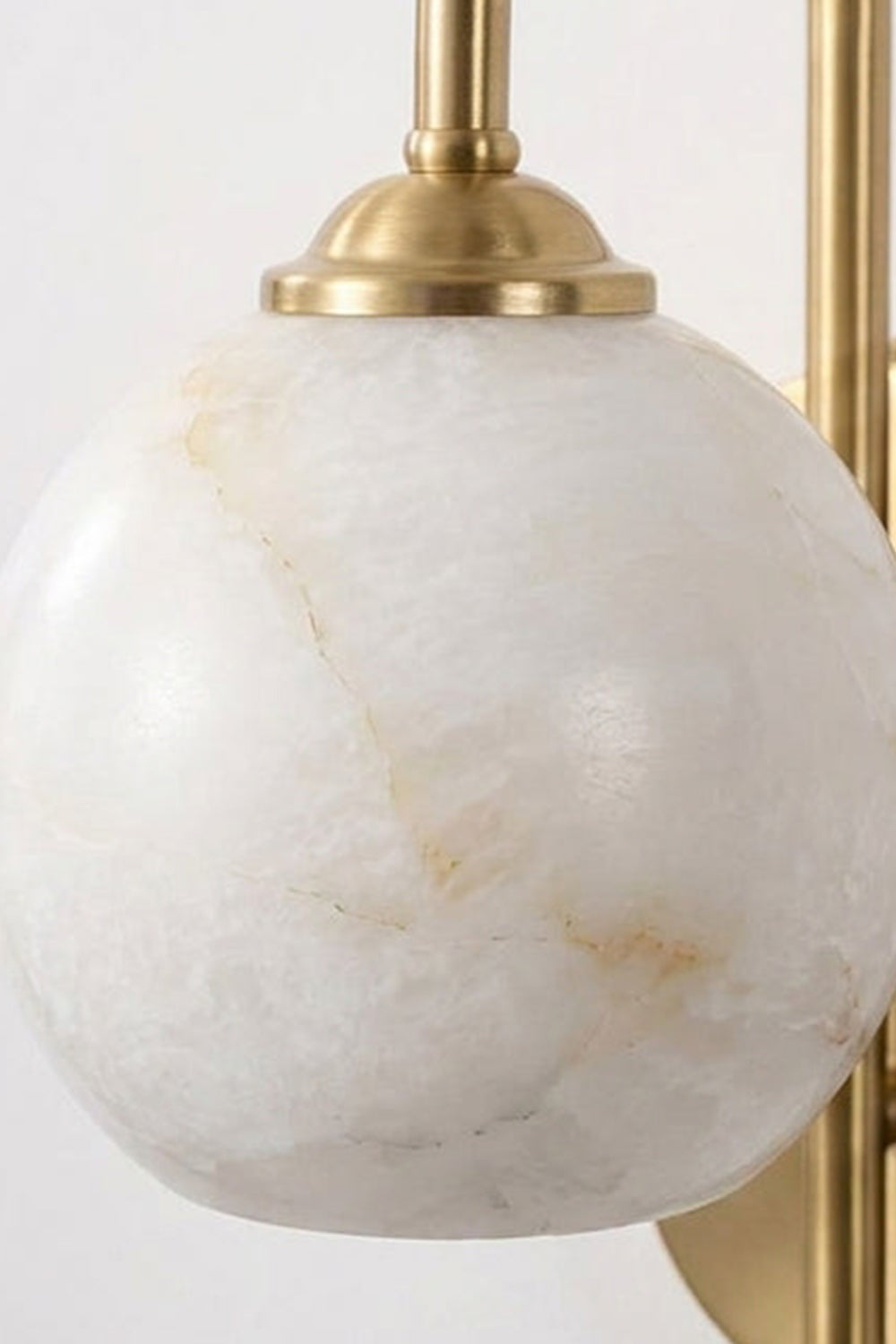 Seraphine Alabaster Globe Wall Sconce with a hand-carved alabaster globe and gold-toned accents for warm accent lighting.