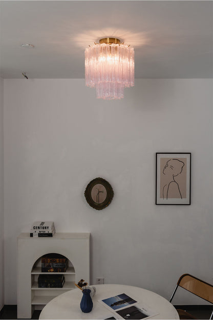 Seraphine Starburst Glass Tube Ceiling Light | Pink Glass and Brass | Glowing softly in a minimalist white dining room over a round table | vexa lamps