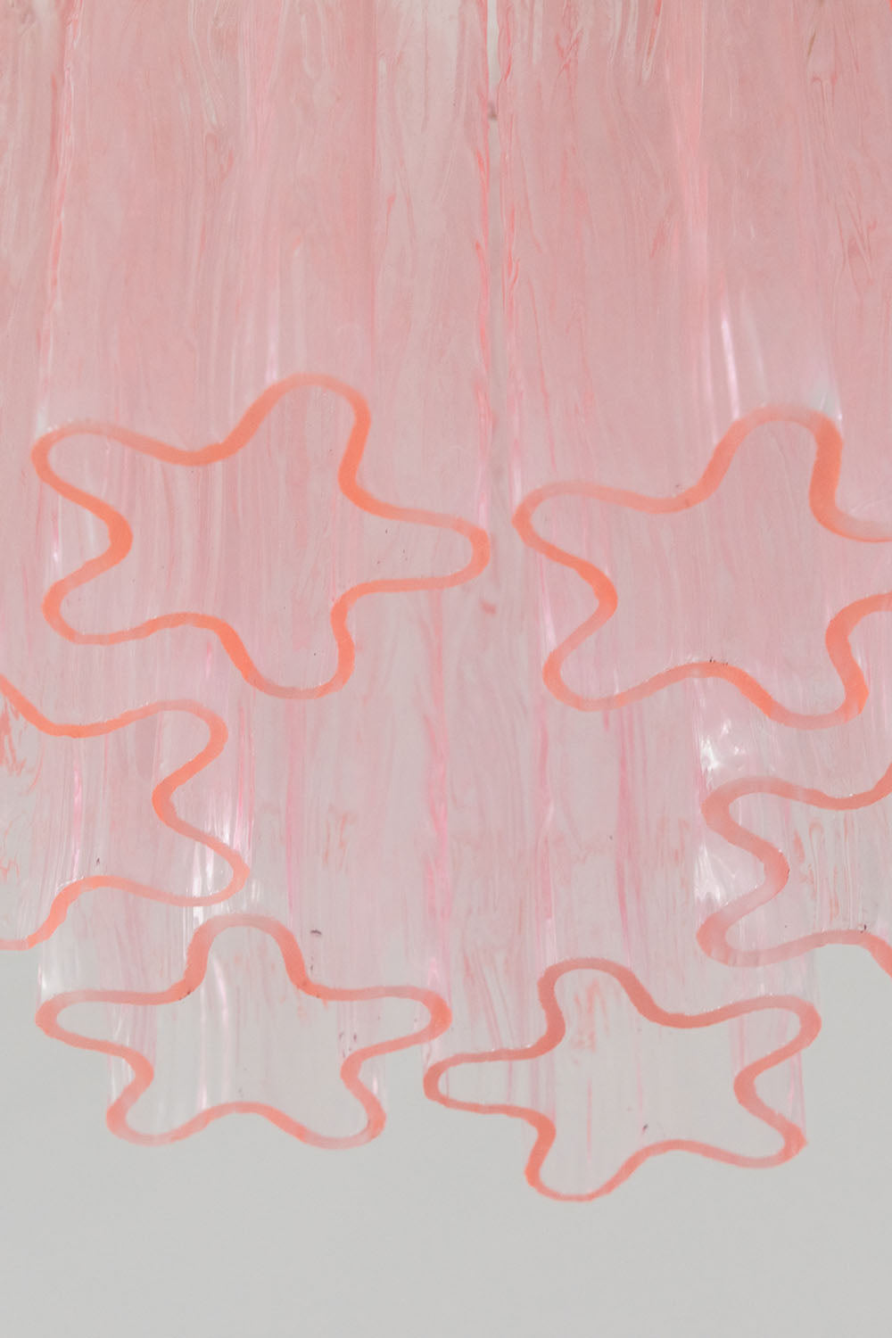 Seraphine Starburst Glass Tube Ceiling Light | Pink Glass and Brass | Detail shot highlighting the star-shaped profile of the pink glass tubes | vexa lamps