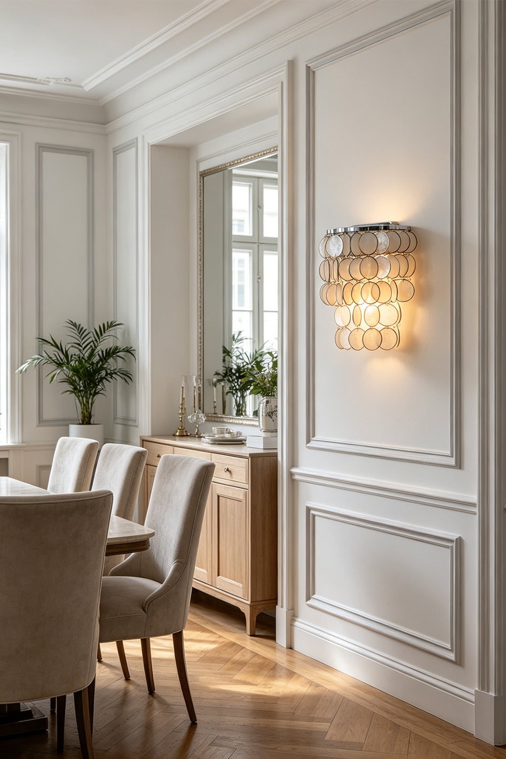 Round Capiz shell wall lamp | Shell | Iron | Mounted on a white paneled wall in a traditional dining room | vexa lamps