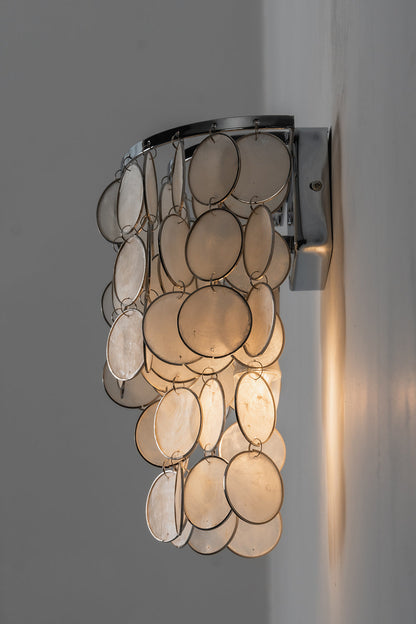Side profile of Capiz shell wall lamp | Shell | Iron | Side view showing layered shell discs and metal bracket | vexa lamps