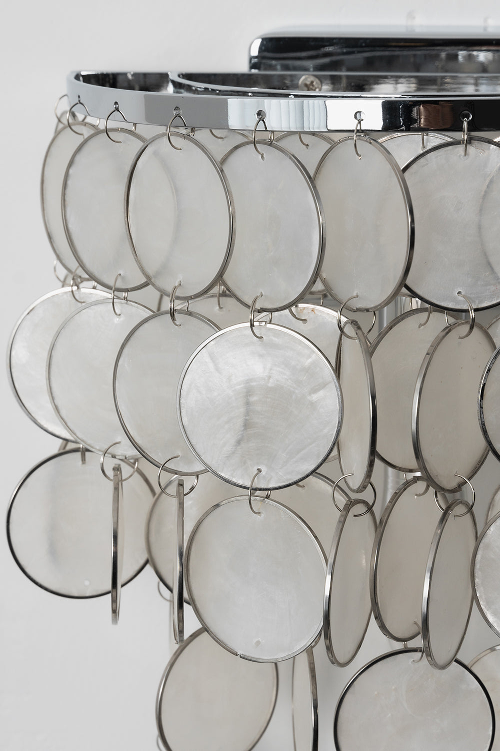 Detailed view of cascading Capiz shells | Shell | Iron | Close-up of metal rings and translucent shell discs | vexa lamps