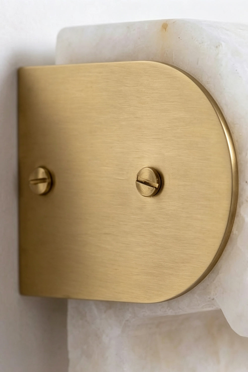 Brushed brass half-moon mount for Soren Stacked Alabaster Wall Sconce attached to alabaster.