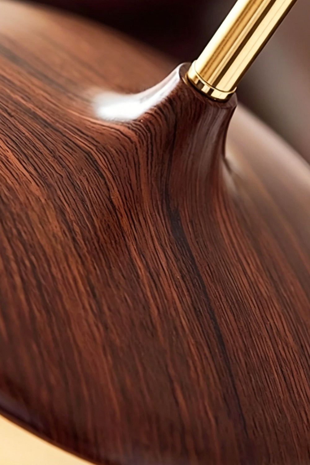 Soren Wood Grain Pendant Lamp | Wood, Glass, Metal | Extreme close-up showing the rich, smooth polished dark walnut wood grain texture and brass neck connection | Detail shot | vexa lamps