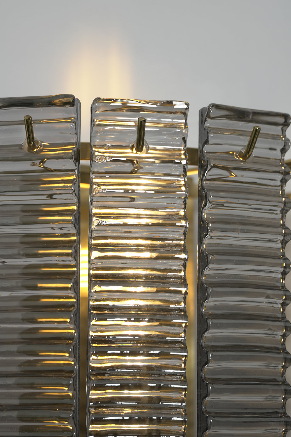 Sovereign Lattice Smoky Glass Wall Lamp with ribbed smoky gray glass and ambient internal illumination.