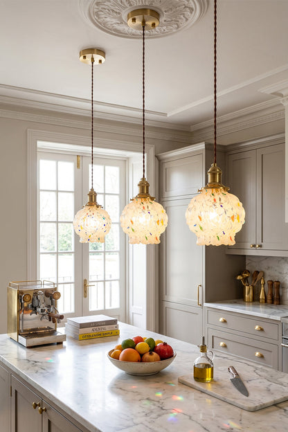 Speckled Bubble Glass Pendant Lamp | Glass, Metal | Three speckled glass pendant lights providing a warm, inviting glow over a clean white marble kitchen counter | vexa lamps